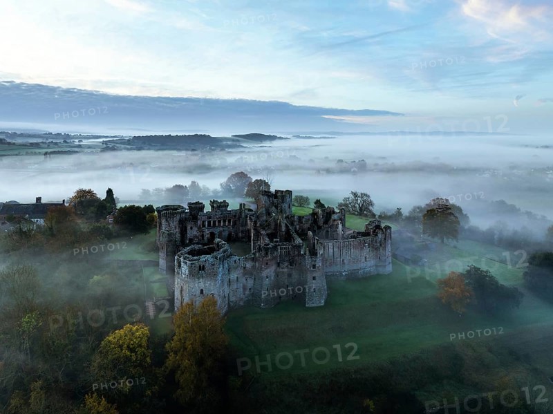Raglan Castle in the fog at dawn from a drone, Monmouthshire, Wales, England, United Kingdom, Europe