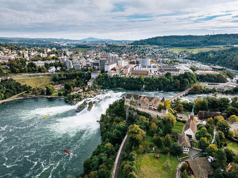 Aerial view of the Rhine Falls with Laufen Castle with autumnal vegetation, on the horizon the town of Neuhausen, and Schaffhausen, Canton of Zurich, Switzerland, Europe
