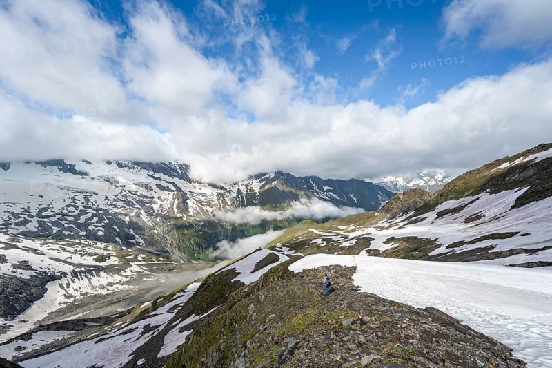 Mountaineer on hiking trail with snow, mountain landscape with summit Hoher Weißzint and Hochsteller with glacier Schlegeiskees, Berliner Höhenweg, Zillertal Alps, Tyrol, Austria, Europe