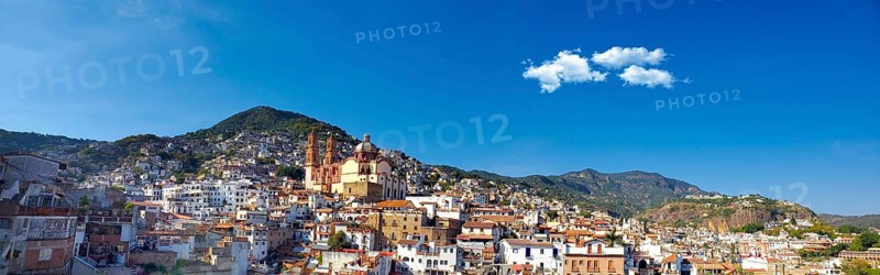 Mexico, Scenic panoramic view of Taxco historic center with colonial houses on the hills and famous Church of Santa Prisca de Taxco, Central America