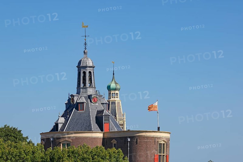 Historic old town of Enkhuizen, spires of the Drommedaris, former defence defence tower at the entrance to the harbour of Enkhuizen, and the Zuiderkerk church (behind), North Holland, West Friesland, Netherlands