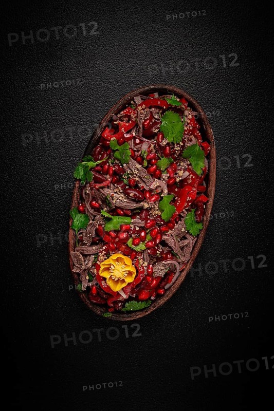 Georgian salad Tbilisi, boiled beef, with red beans and onions, sweet pepper, walnut and pomegranate, homemade, no people