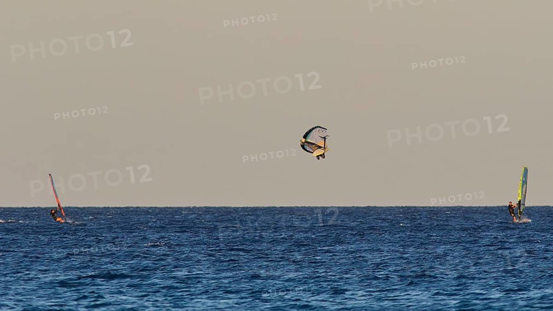 Wingfoiller, A windsurfer performs a jump in the air, Windsurfer, Meltemi windsurfing spot, Devils Bay, Paralia Vatha, Vatha Beach, Southeast coast, Karpathos, Dodecanese, Greek Islands, Greece, Europe