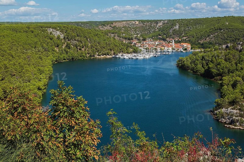 Marina plus commercial and residential buildings with traditional terracotta clay roof tiles in Skaradin town on edge of the Krka river taken from Krka belvedere in late summer, Dalmatian Coast, Croatia, Europe