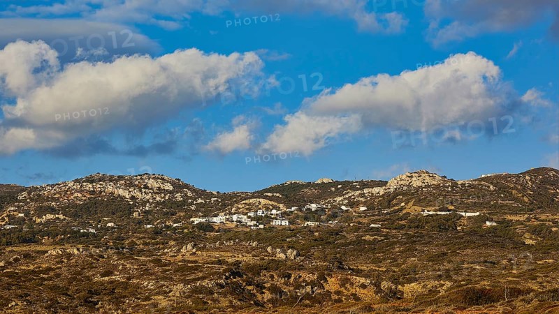 View of a hilly landscape with grassy hills under a blue sky with white clouds, West Coast, Karpathos, Dodecanese, Greek Islands, Greece, Europe