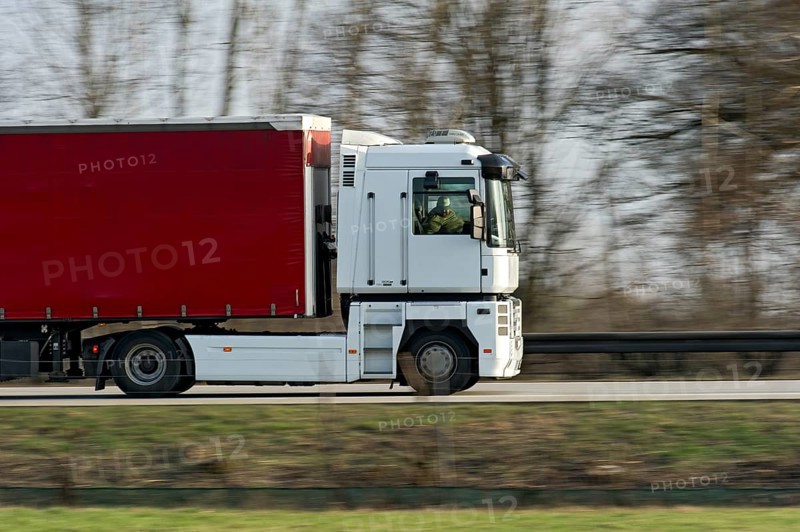 Unconcentrated driver in truck, lorry, articulated lorry driving fast on the A92 motorway, Renault Magnum 500, motion blur, wiping effect, Freising, Upper Bavaria, Bavaria, Germany, Europe
