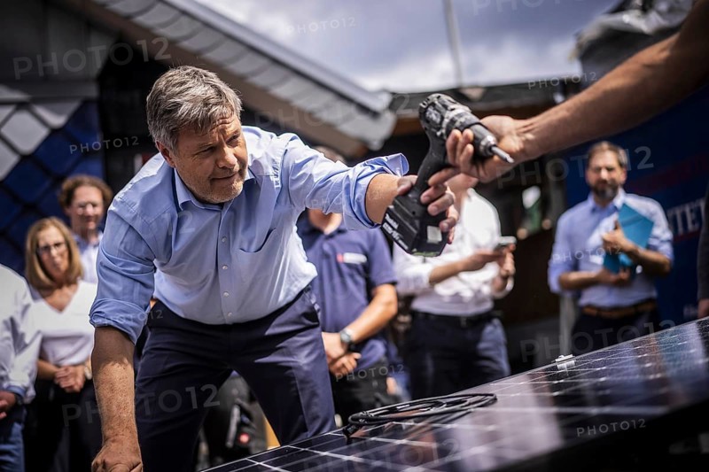 Federal Minister for Economic Affairs and Climate Protection Robert Habeck (Alliance 90/The Greens) on a summer tour of Germany. Here in Bochum, 10 July 2024, visiting a roofer with solar roof elements Photographed on behalf of the BMWK