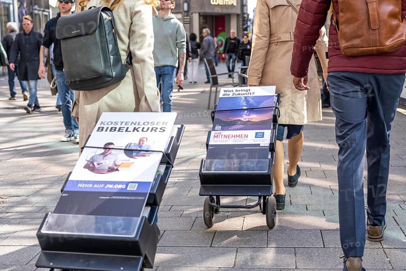 Jehovah's Witnesses with mobile information stands, with information in various languages, in the pedestrian zone at Cologne Cathedral