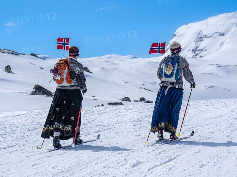 National day 17th May, Norwegians hike on ski, carrying norwegian flags, hike from Finse, highest railway station on railroad line Oslo-Bergen, to glacier Hardangerjøkull, Hardanger, Norway, Europe
