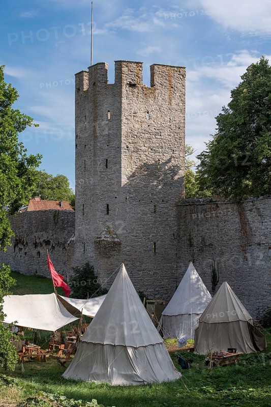 Camp in front of historic city wall with defence defence tower, Medieval Week, Hanseatic City of Visby, UNESCO World Heritage Site, Gotland Island, Sweden, Europe