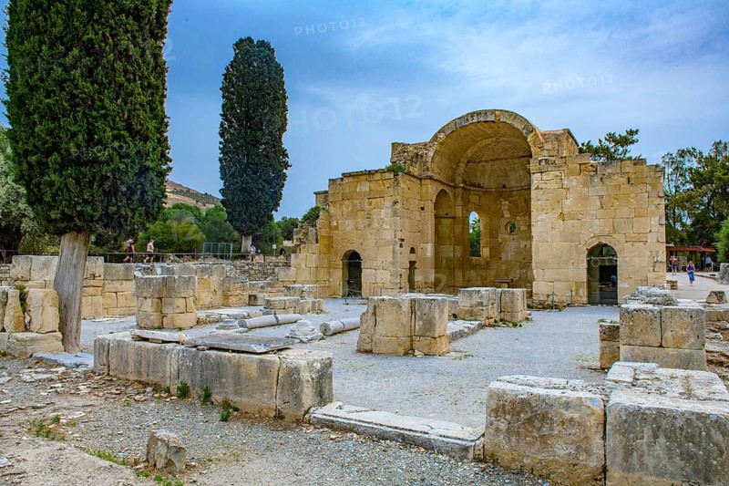 View of ancient ruins of Titus Basilica, in the foreground remains of stones foundation walls of portal next to columns in the background chancel of early Christian basilica from 6th century in remains excavation site of ancient Roman city Gortys Gortyn former capital of Crete, Gortyna, Crete, Greece, Europe