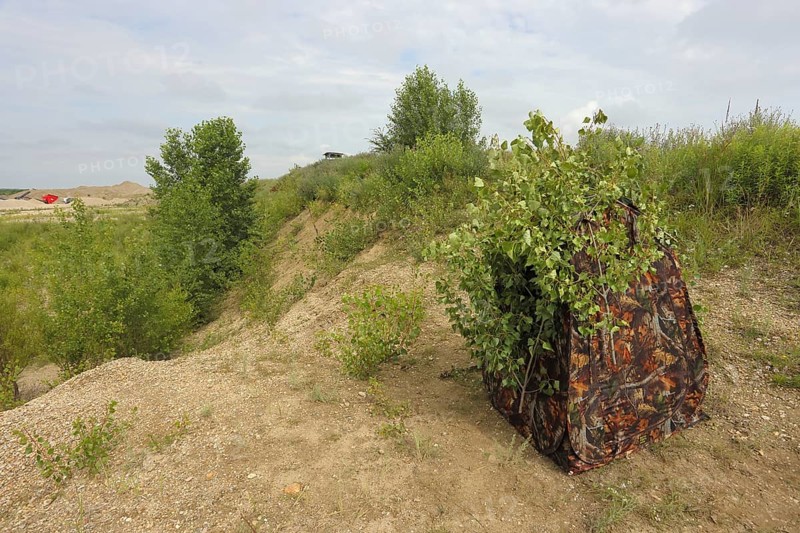 Camouflage tent of a nature photographer in a sand pit, camouflage hiding place, Lake Neusiedl National Park, Seewinkel, Burgenland, Austria, Europe