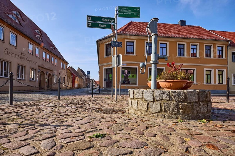 Historic public hand pump, signpost to the museum and Marienstern Monastery, Mühlberg Elbe, Elbe-Elster district, Brandenburg, Germany, Europe