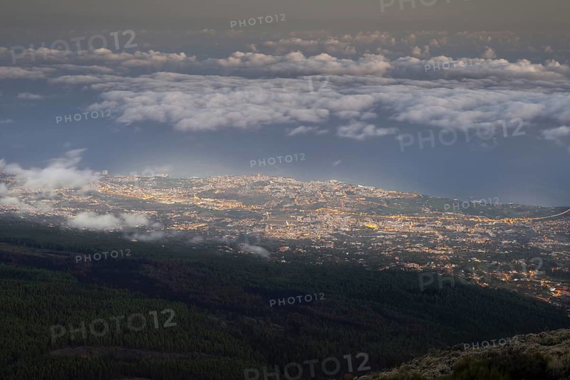 Night view from the Teide National Park, Parque Nacional del Teide, to the illuminated Orotava, Puerto de la Cruz and trade wind clouds over the Atlantic Ocean, Tenerife, Canary Islands, Spain, Europe