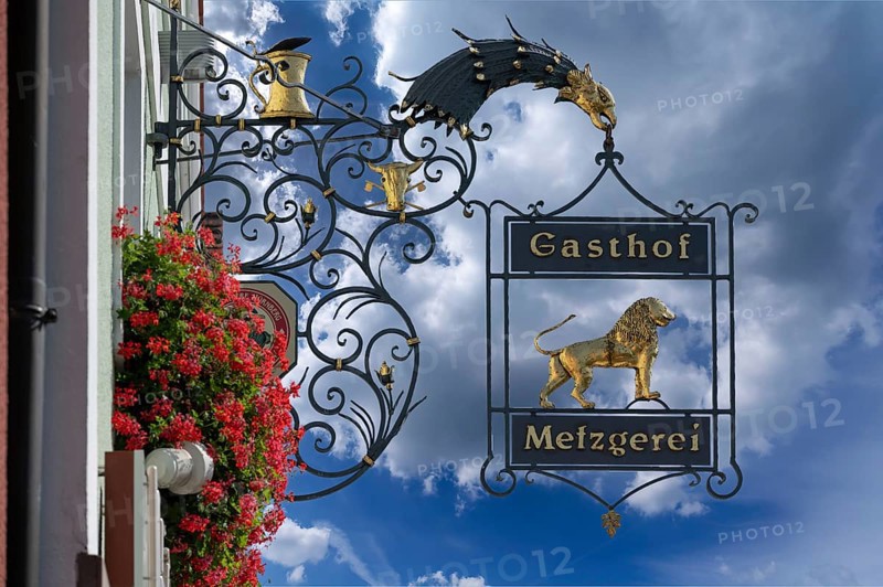 Nose sign of the Goldener Löwe inn and butcher's shop, behind the church of the Assumption of the Virgin Mary, Allersberg, Middle Franconia, Bavaria, Germany, Europe