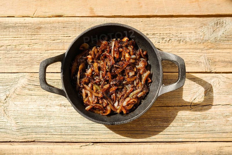 Top view of caramelized onion in cast iron frying pan