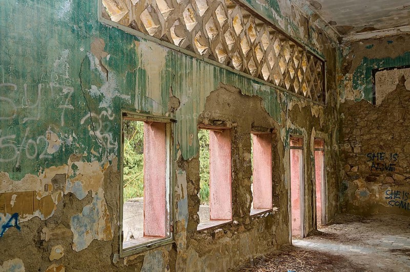 Dilapidated building with colourful, peeling paint and graffiti, whose many windows expose a destroyed wall decoration, Italian governor's palace, Ruins, Italian colonial settlement, Eleousa, Rhodes, Dodecanese, Greek Islands, Greece, Europe