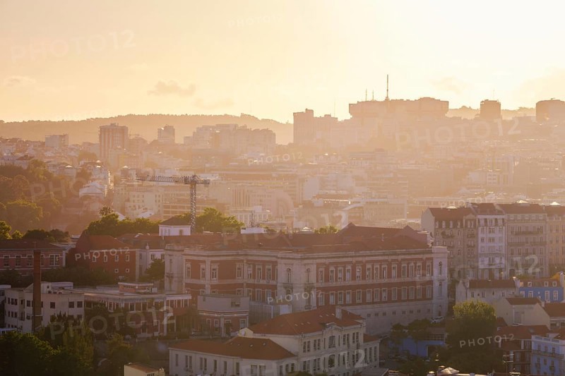 View of Lisbon famous view from Miradouro da Senhora do Monte tourist viewpoint in contre-jou on sunset. Lisbon, Portugal, Europe