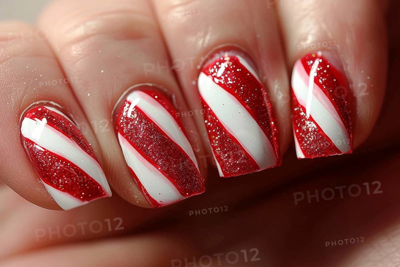 Woman's fingernails with red and white colored nail polish with seasonal Christmas candy cane themed design. Generative Ai, AI generated