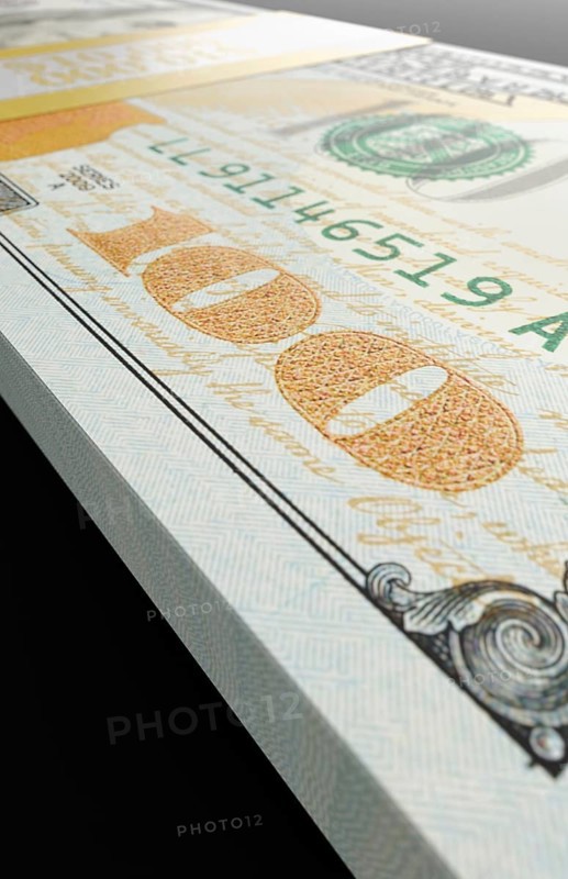Ten thousand dollar stack of one hundred dollar bills close-up abstact.