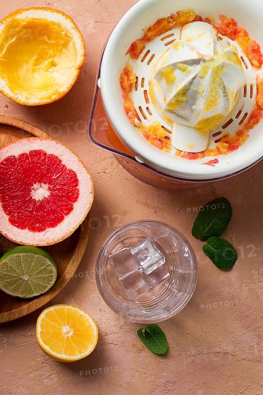 Citrus juicer, sliced fruit, glass with ice, close-up, no people, breakfast