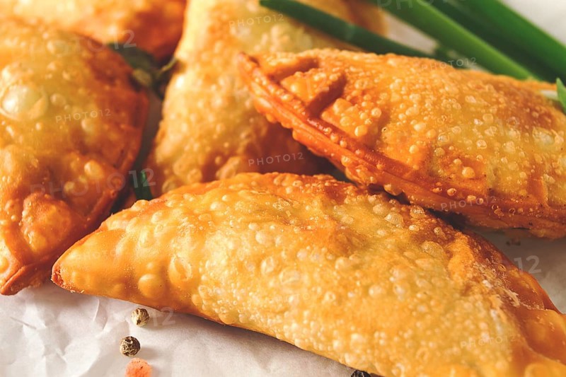 Fried chebureks, close-up, on a light background, no people