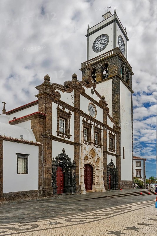 Historic church with ornate entrance gate and clock tower against a cloudy sky, Igreja Matriz de São Sebastião, Ponta Delgada, Sao Miguel Island, Azores, Portugal, Europe