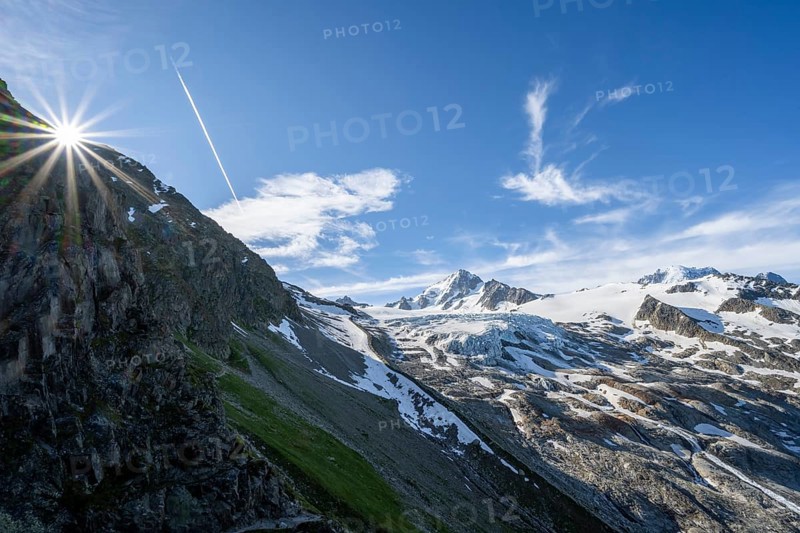 High alpine mountain landscape with sun star, summit of Aiguille de Chardonnet and Glacier du Tour, glacier and mountain peaks, Chamonix, Haute-Savoie, France, Europe