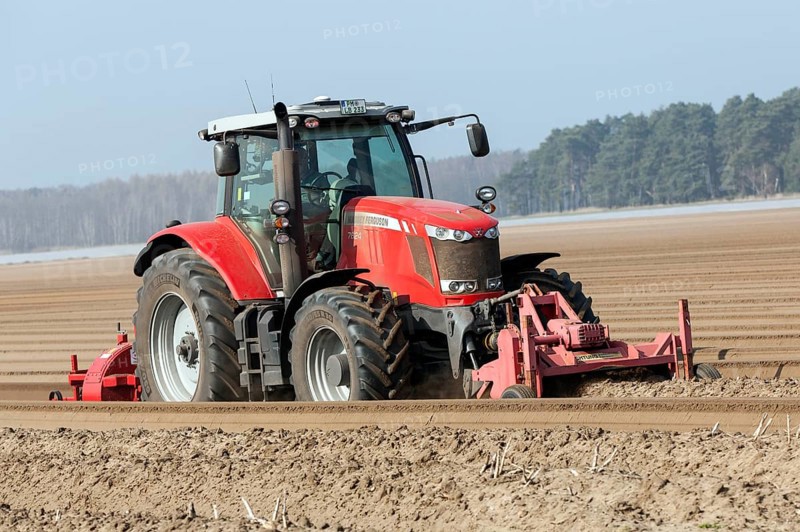 Preparations for the asparagus season. The soil is loosened with a tiller at the front of the tractor, the rear tiller of the tractor creates the typical asparagus mound, Klaistow, 07.03.2014., Klaistow, Germany, Europe