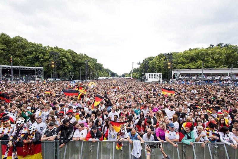 Football fans in the fan zone at the Brandenburg Tor during the quarter-final match between Germany and Spain at the European Football Championship, Berlin, 05/07/2024
