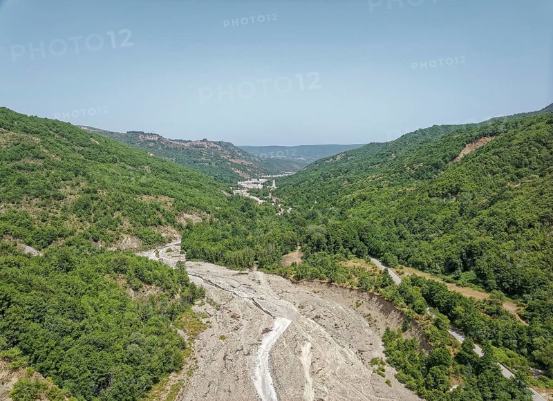 Only a trickle of water flows through the largely dry bed of the Torrente Nocito stream. Aerial view. San Chirico Raparo, Basilicata, Southern Italy, Southern Europe