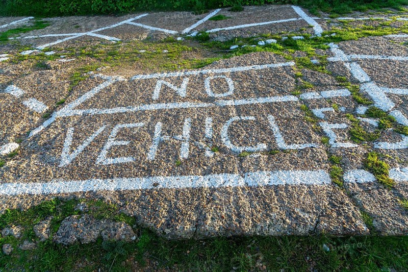 No Vehicles painted sign on ground surface to restrict parking, Shingle Street, Suffolk, England, UK