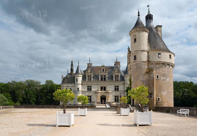 Imposing castle with ornamental towers and white tubs on a gravel path, Chenonceau Castle, Château de Chenonceau, moated castle, Cher River, Marques Tower on the right, Chenonceaux, Indre-et-Loire, Centre-Val de Loire, France, Europe