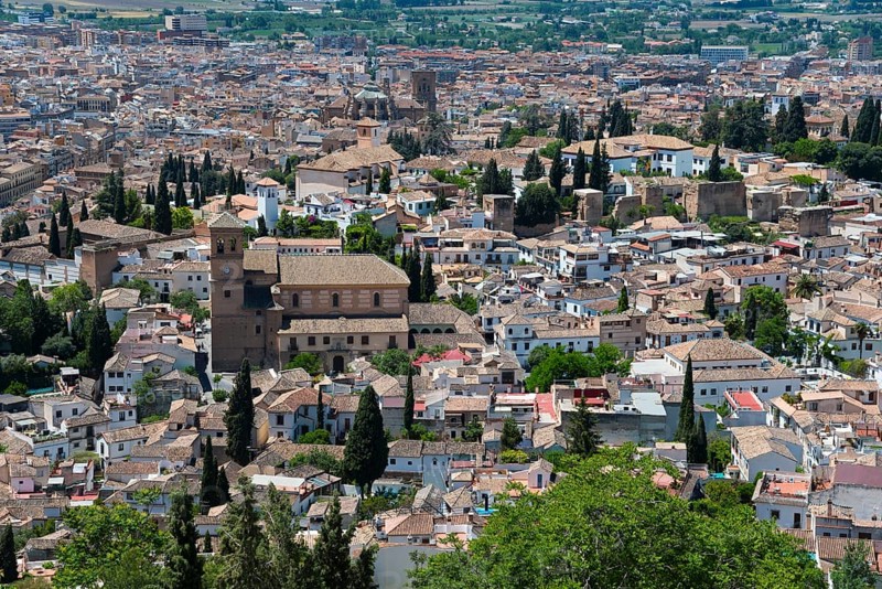 View over a historic town with brick houses, green vegetation and a peaceful Mediterranean atmosphere in sunny weather, Albayzín district, Albayzin, Cerro del Aceituno hill, Albayzín, Granada, Andalucia, Spain, Europe