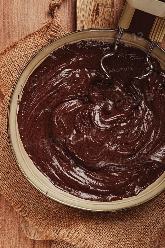 A bowl of chocolate dough, a whisk for a mixer, baking, structure and consistency, homemade, top view, no people