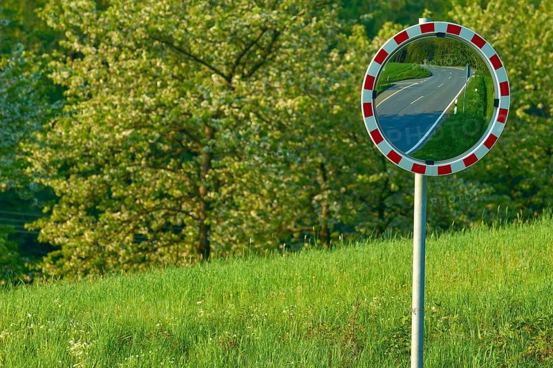 Traffic mirror reflecting a road, trees and meadow in the background, Odenwald, Hesse, Germany, Europe