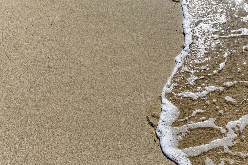 Gentle wave on the shore blurs footprint in the sand, Simos beach, text free space, symbolic photo, moment, transience, walk, Elafonisos, Ionian Sea, Greece, Europe