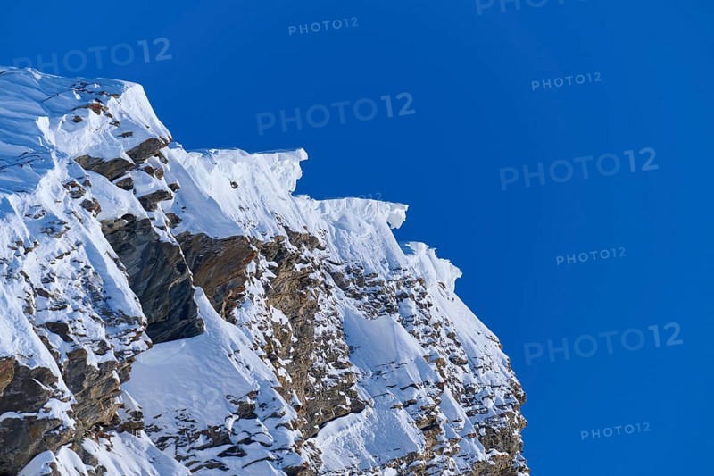 Snow-covered mountain peak with snow cornices under a clear blue sky, Gemmi Pass, Plattenhörner, Leukerbad, Leuk, Valais, Switzerland, Europe