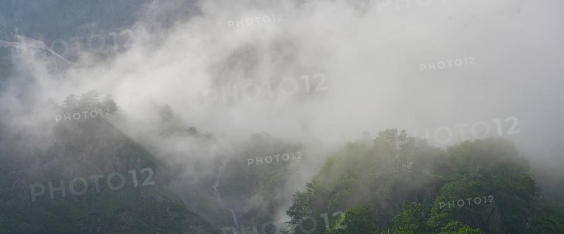 Clouds move over the mountains after a rain shower at Lago della Rovina, Entracque, province of Cuneo, Italy, Europe