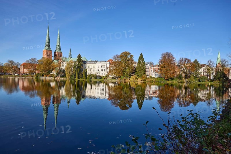 Mill pond with general buildings, Lübeck Cathedral and trees, symmetrical reflections on the water surface, blue cloudless sky, Hanseatic City of Lübeck, independent city, Schleswig-Holstein, Germany, Europe