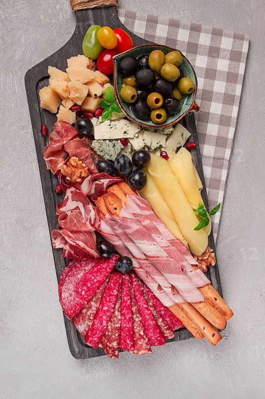 Appetizer, assortment, set, sausage, and cheese, on a wooden board, top view, no people