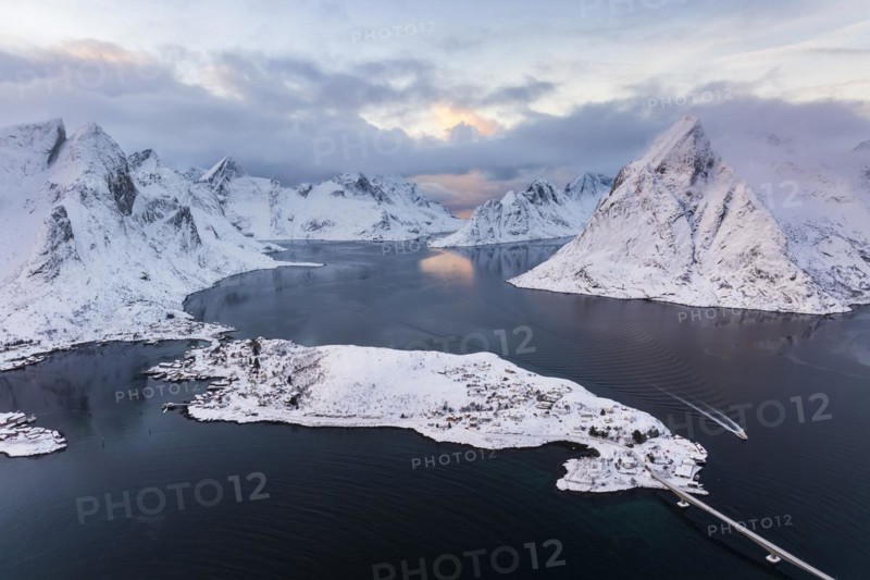 View of snow-covered islands, fjord and mountains, fishing village of Reine, Reinefjord, Lofoten, Norway, Europe