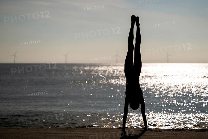 Girl doing a handstand by the sea, Silhouette, Søndervig Strand, North Sea, Denmark, Europe