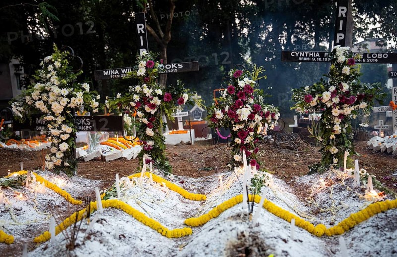 People from Christian community light candles and offer prayers on the grave of their relative during the All souls day observation, in Guwahati, India on 2 November 2024. All Souls' Day is a Christian holiday dedicated to honoring and praying for the souls of the departed