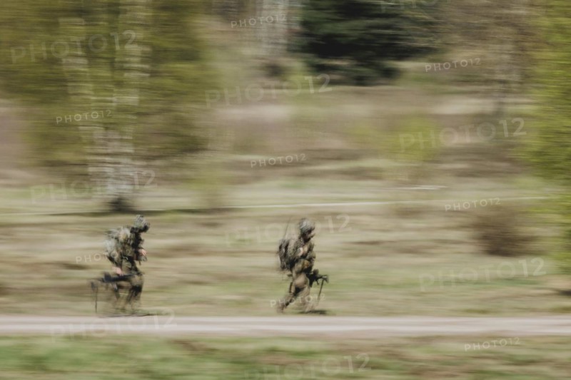 Two equipped soldiers, photographed as part of a Bundeswehr exercise with forces from Norway and the Czech Republic during the 'Wettiner Schwert' exercise as part of Quadriga 2024 in the training town of Schnöggersburg, 8 April 2024