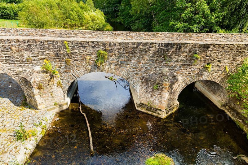 Old Mulde Bridge Stone Bridge Built in 1501 Next to the normal village road, hikers and cyclists will find a historic stone bridge. The old Mulde bridge next to the concrete bridge was built in 1501. It replaced the wooden footbridge of the oldest Dresden country road, Halsbrücke, Conradsdorf, Saxony, Germany, Europe