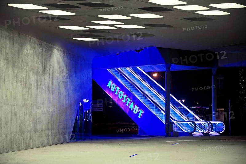 Illuminated escalator to the Autostadt under the phæno building at night, Wolfsburg, Lower Saxony, Germany, Europe