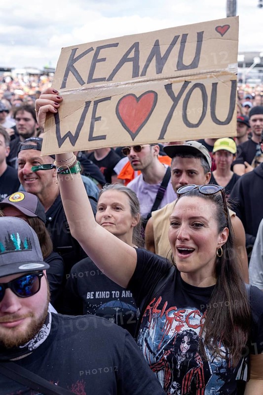Adenau, Germany, 8 June 2024: A female fan holds up a sign with the inscription: Keanu We Love you (Keanu wir lieben Dich) while Dogstar (bass, Keanu Reeves) play at Rock am Ring. The festival takes place at the Nürburgring race track near the town of Adenau from 7 to 9 June 2024, Europe