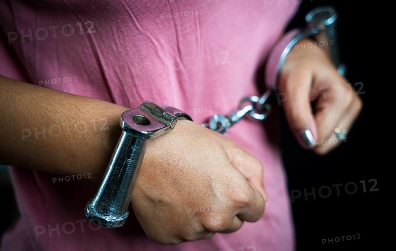 Woman hands in handcuffs- concept image