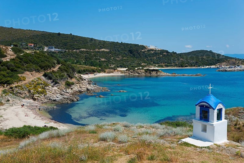 Small chapel with blue roof on a rocky coast with clear sea water, Greek Orthodox shrine, beach near Sarti, Sithonia, Chalkidiki, Central Macedonia, Greece, Europe